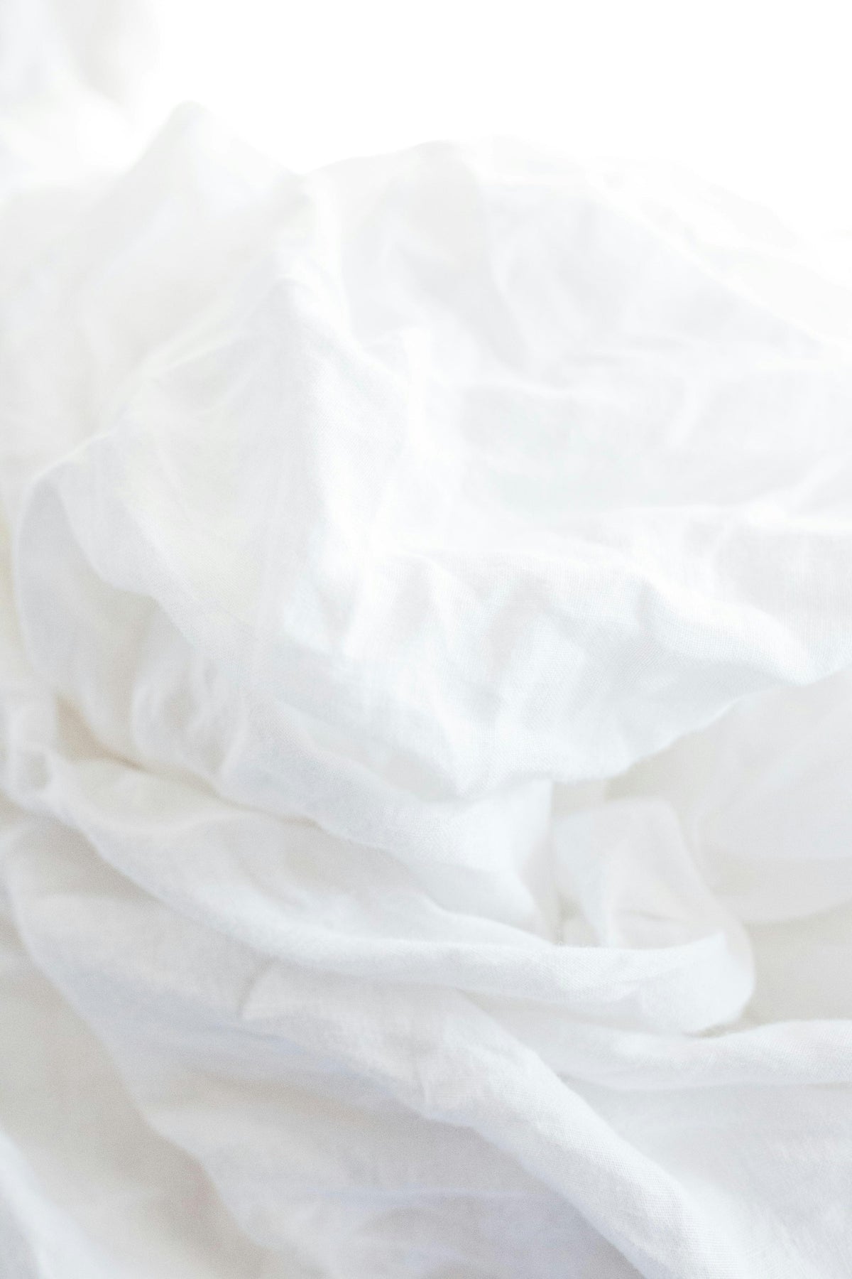 A close detail of softly folded white linen.